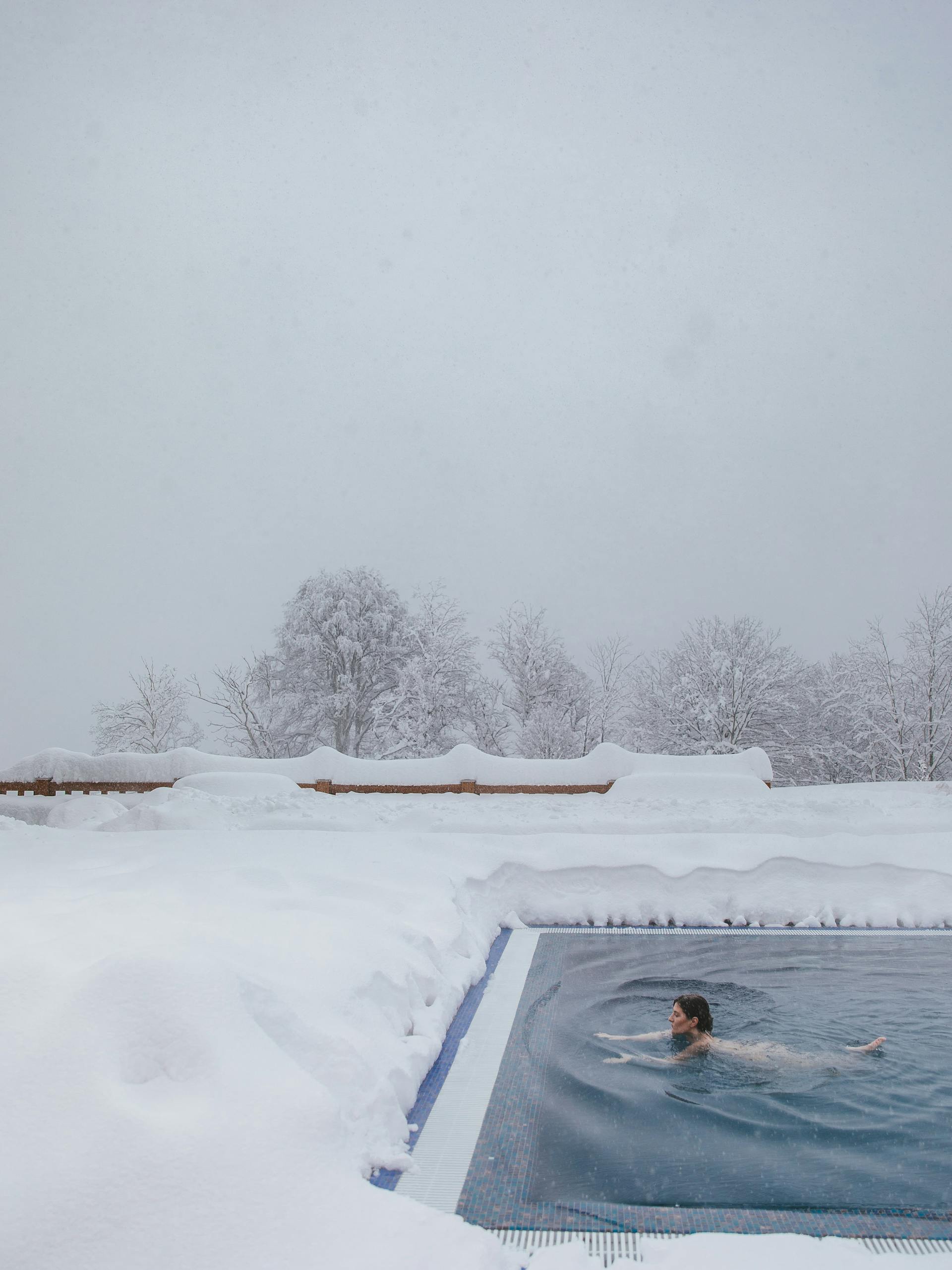 woman taking ice bath outdoors snow cold weather