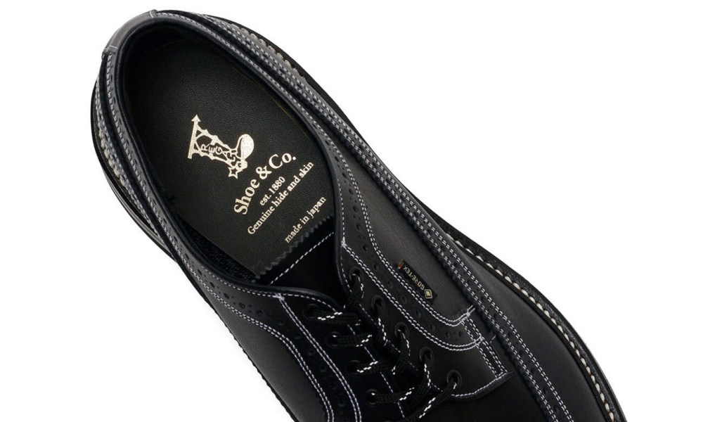 close up on insole of black wingtip shoe