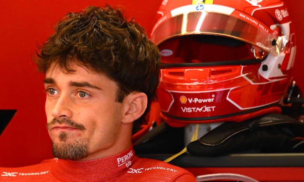 Ferrari F1 driver Charles Leclerc sitting in race car.