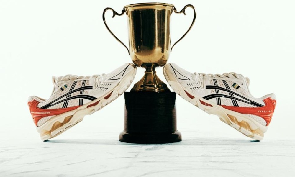 white and red sneakers next to trophy