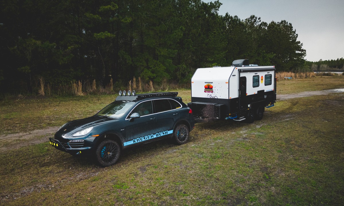 A Kruger Bush camper being pulled through a back country road.