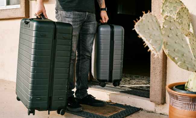 Man carrying luggage in both hands