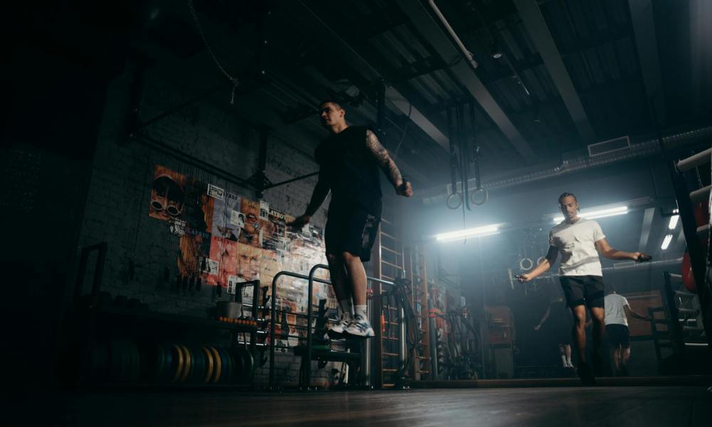 man jumping rope in gym jump rope aerobic cardio exercise