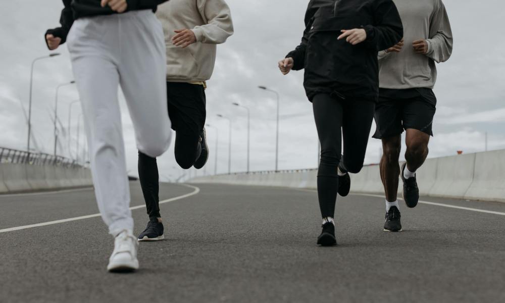 people group running together outside on road