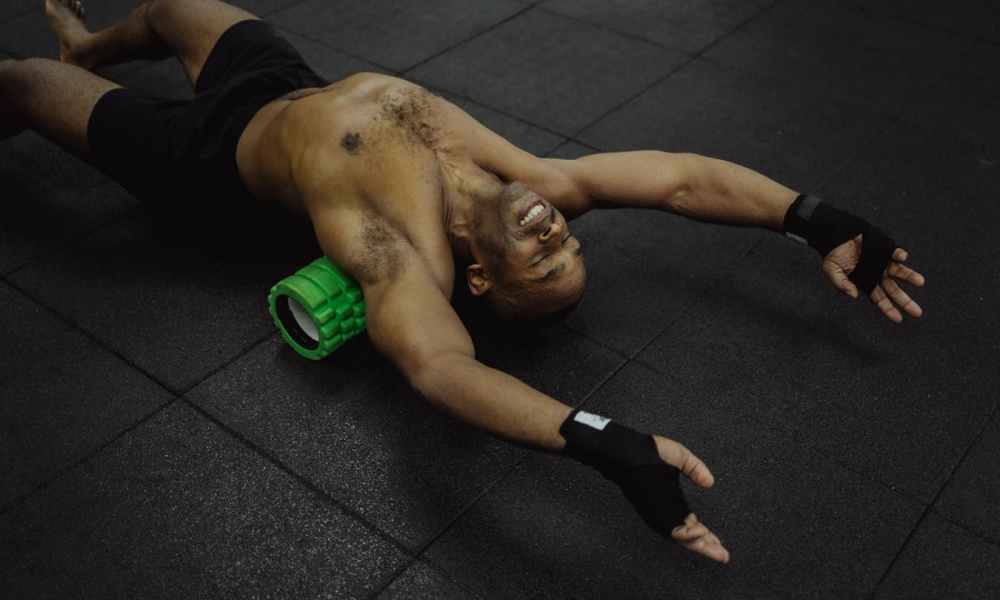 man foam roller smiling warm up stretch