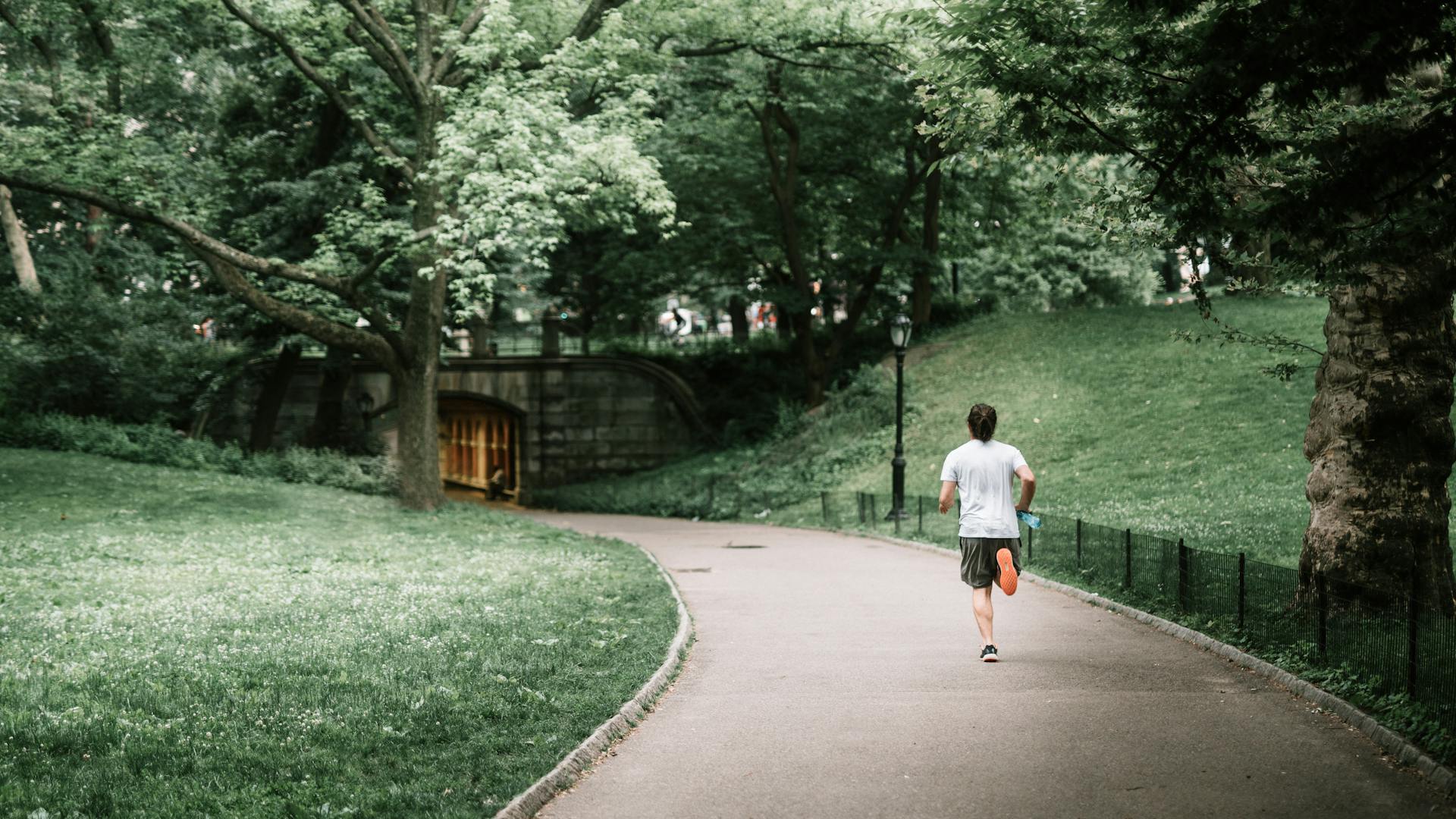 Man running jogging outdoors outside in nature on path