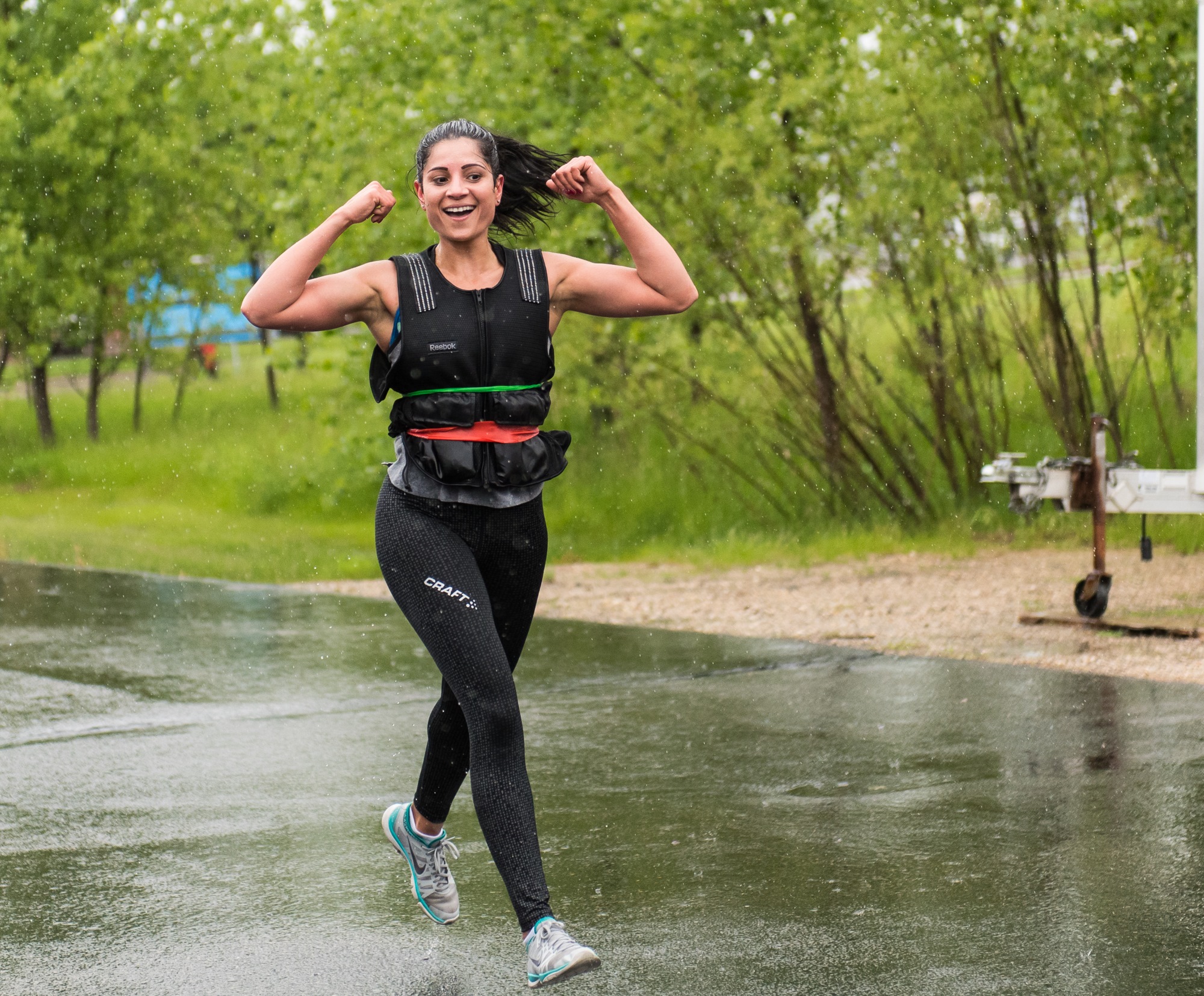 woman wearing weighted vest happy walking working out outdoors