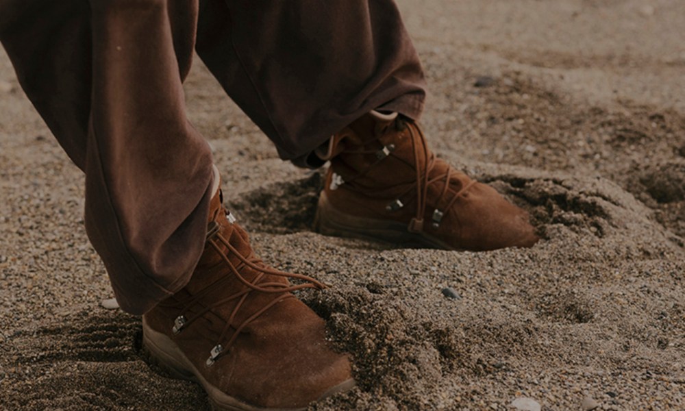 man wearing hiking boot in sand