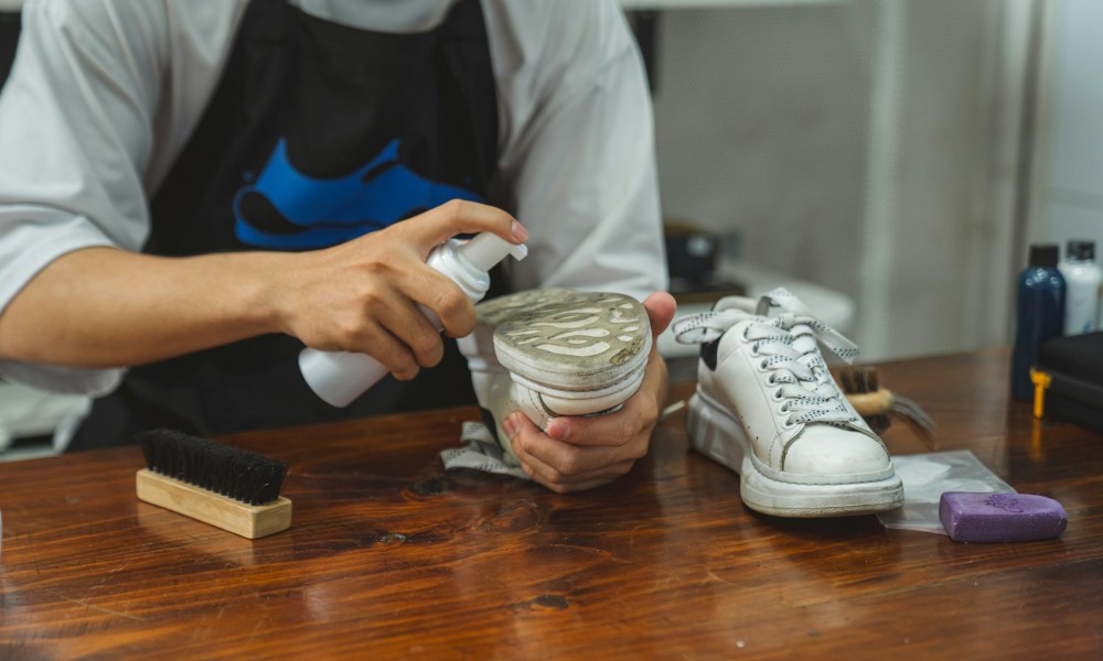 person cleaning shoe sole