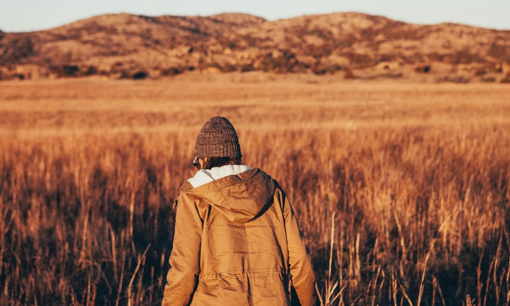 Person walking through the prairie at Wichita Mountains National Reserve