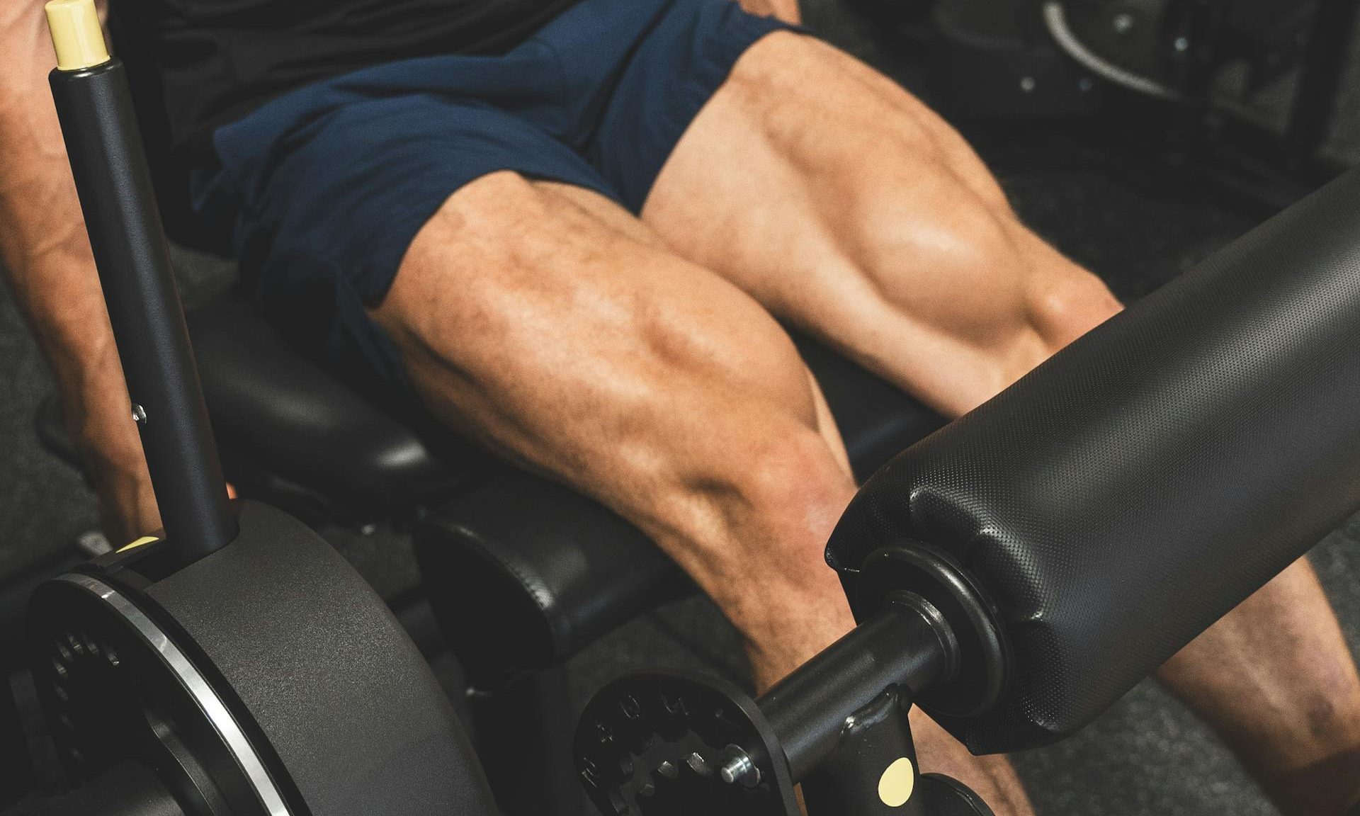 Close-up of quads muscles during leg press exercise