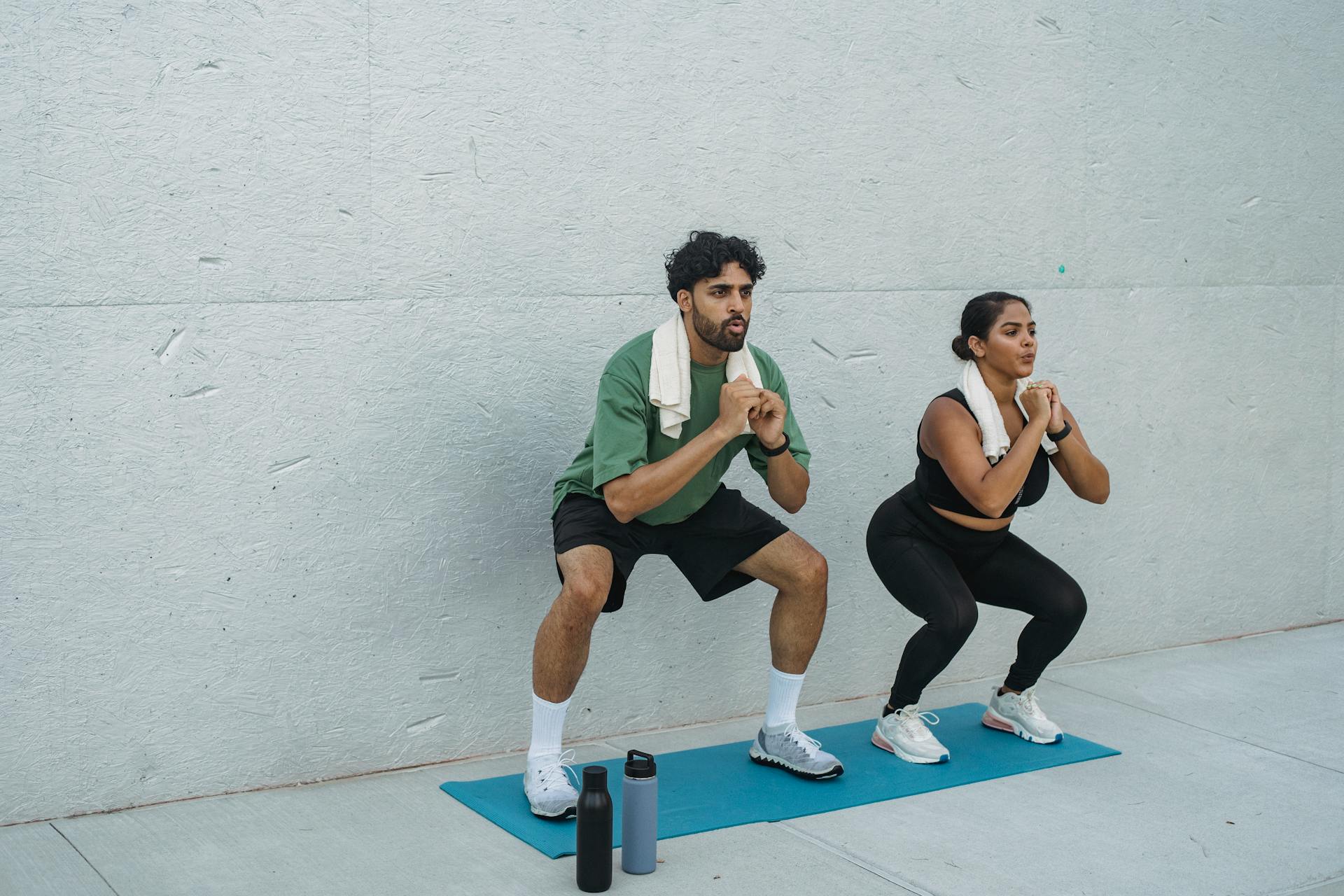 two people squat their body weight