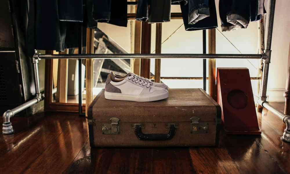 Shoes sitting on top of a suitcase