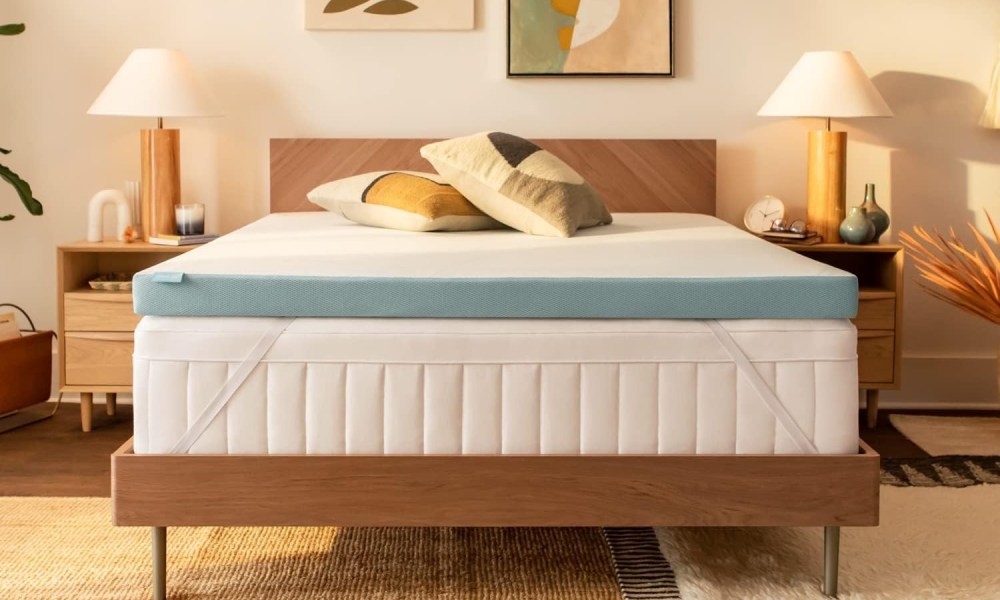 The Tempur-Pedic Adapt + Cooling Mattress Topper on a bed.