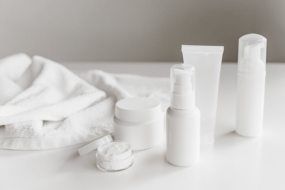 White skincare products on white counter