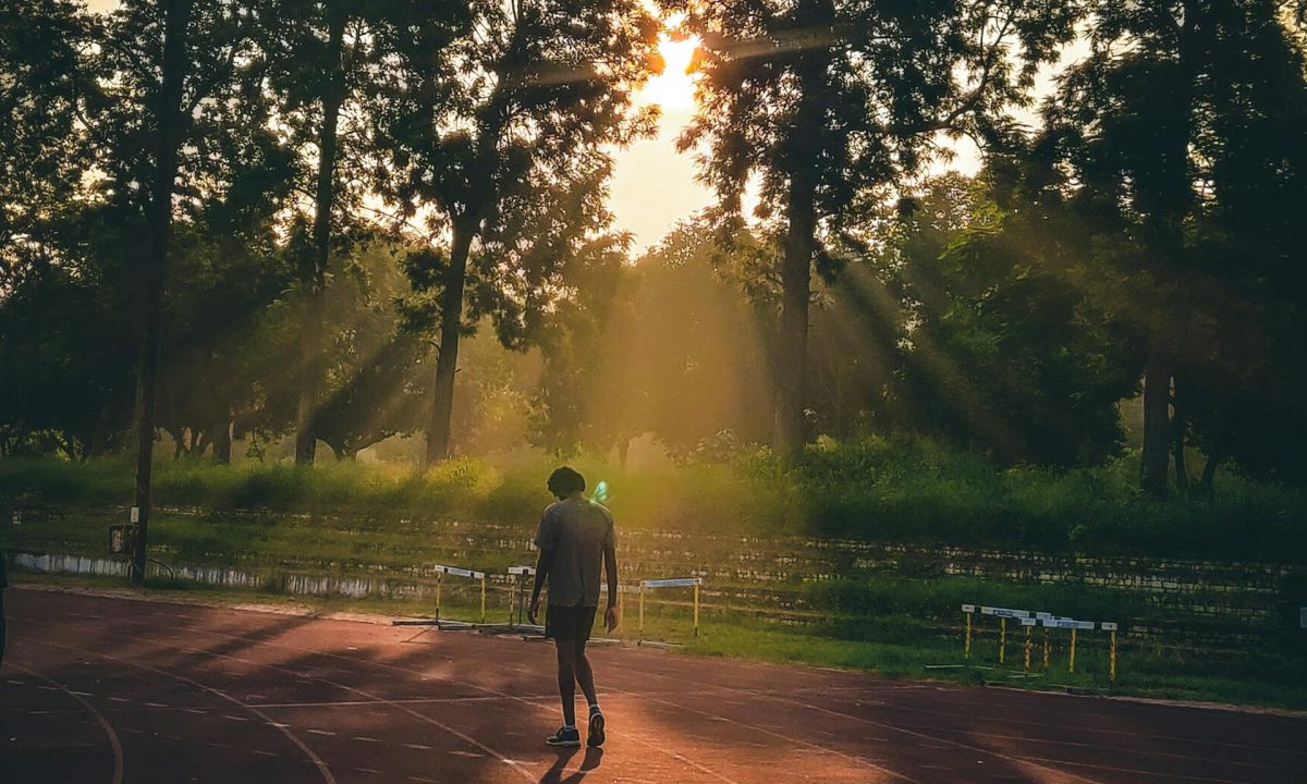 man on running track sunrise sunset